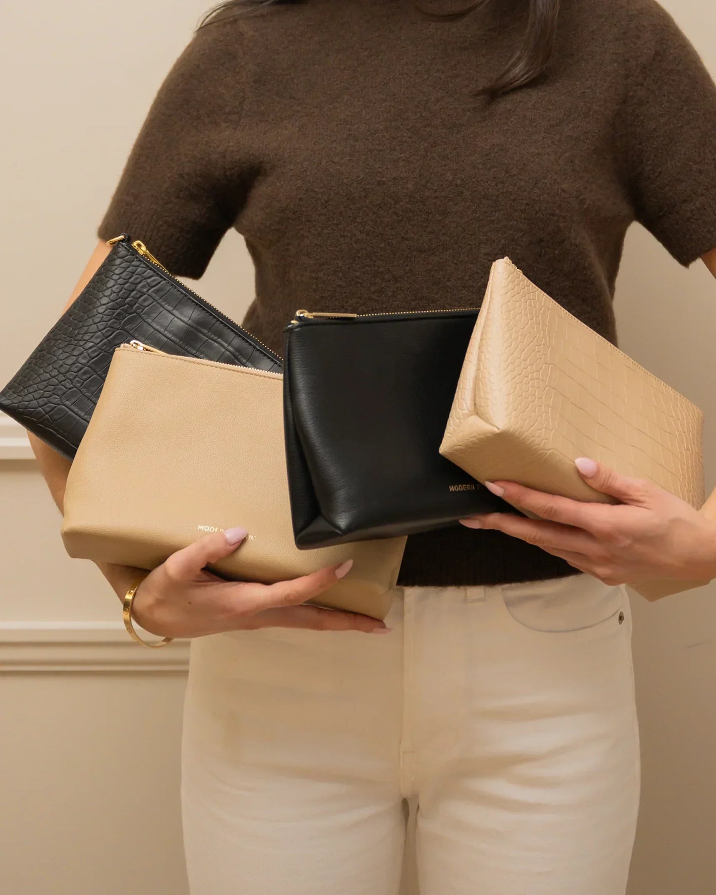 Stylish vegan leather pouches in black and beige, perfect for chic everyday use and travel.