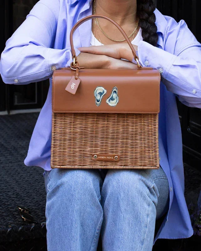 Stylish woven lunch tote with oyster design, perfect for chic picnics and daily use.