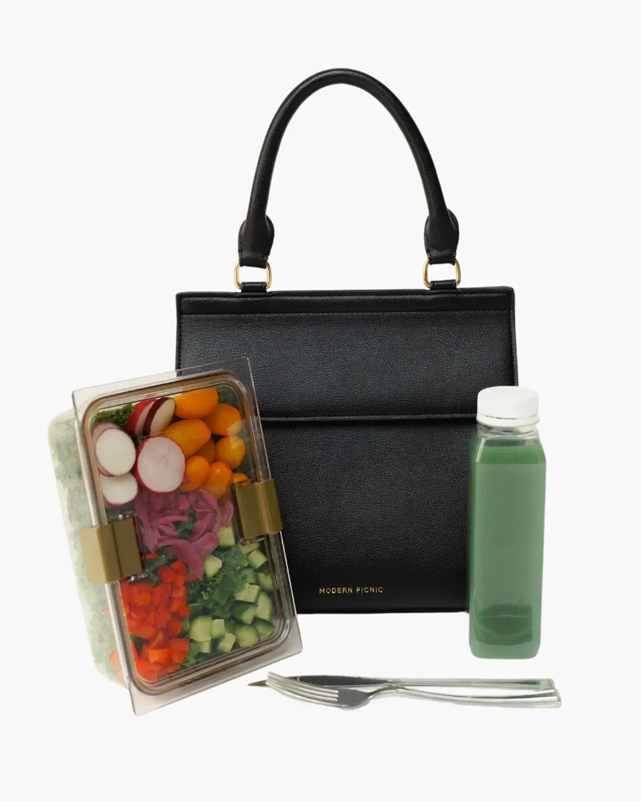 Black vegan leather lunch tote with fresh salad, green juice, and utensils for healthy work meals