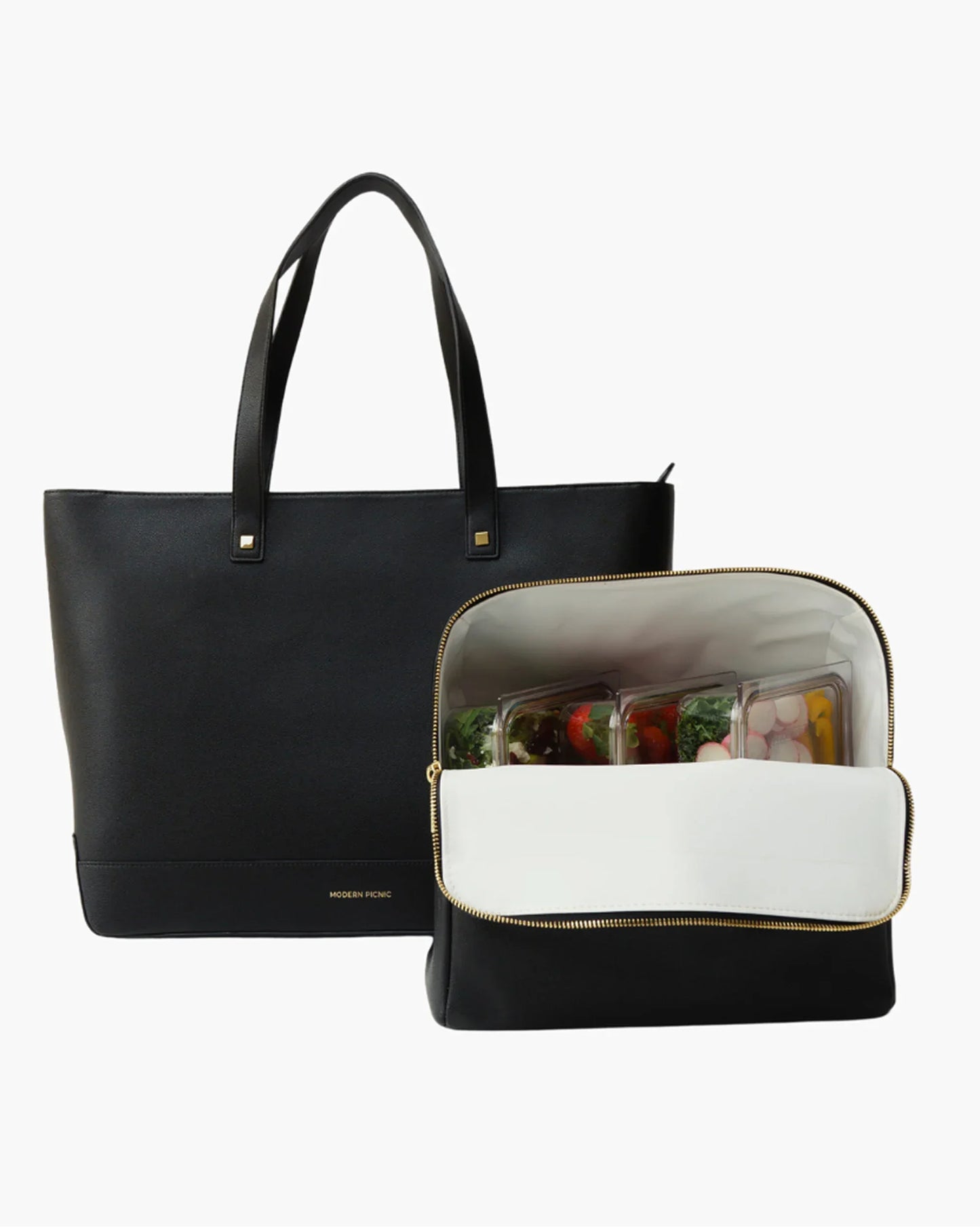 Black insulated lunch tote with gold zipper, holding meal prep containers of fresh food, perfect for work or travel.