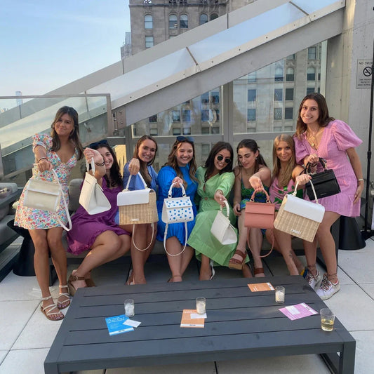 Women showcasing stylish insulated lunch bags and totes on rooftop, perfect for work or picnics