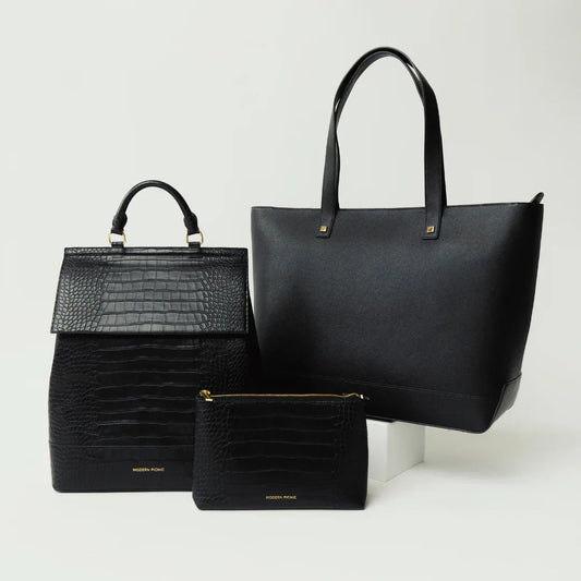 Three black vegan leather bags including a textured backpack, tote, and pouch on white background.