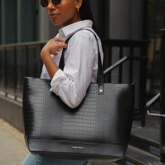 Black croc-texture vegan leather tote bag for work or travel, styled with white shirt and sunglasses