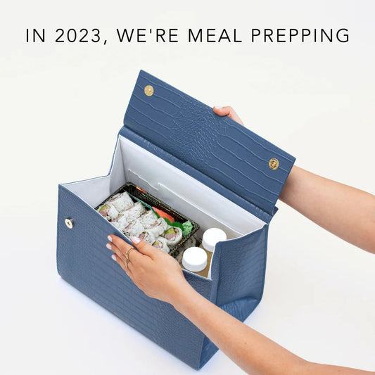 Blue textured lunch bag with sushi and drinks, perfect for meal prep and on-the-go dining.