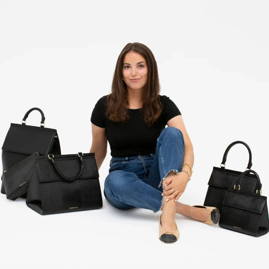 Woman sitting with black vegan leather lunch bags and totes for work, travel, and everyday use