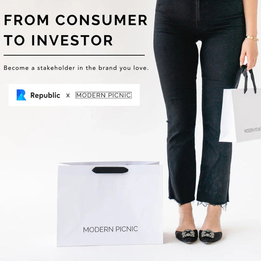 Woman holding Modern Picnic branded shopping bags, promoting consumer to investor opportunity with Republic