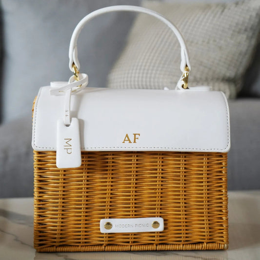 Chic insulated wicker lunch bag with white vegan leather top and gold initials AF.