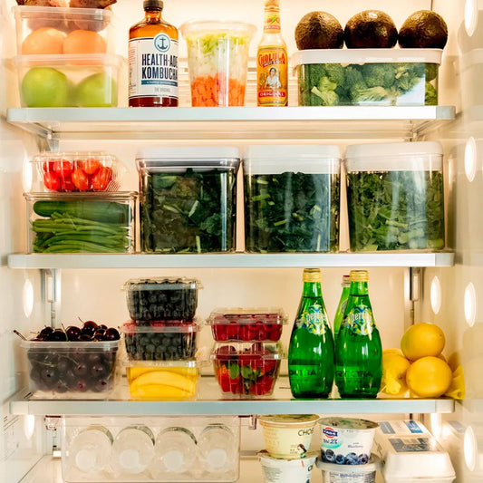 Organized fridge with fresh produce, kombucha, and healthy snacks for meal prep and on-the-go lunches