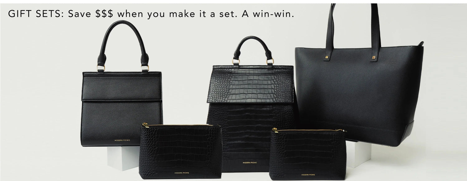 Set of black vegan leather lunch bags, totes, and pouches with chic, modern design