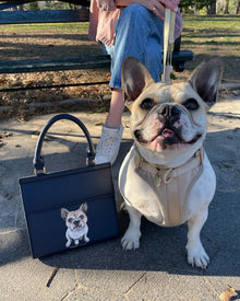 French bulldog with a navy vegan leather insulated lunch bag featuring a dog illustration, outdoors