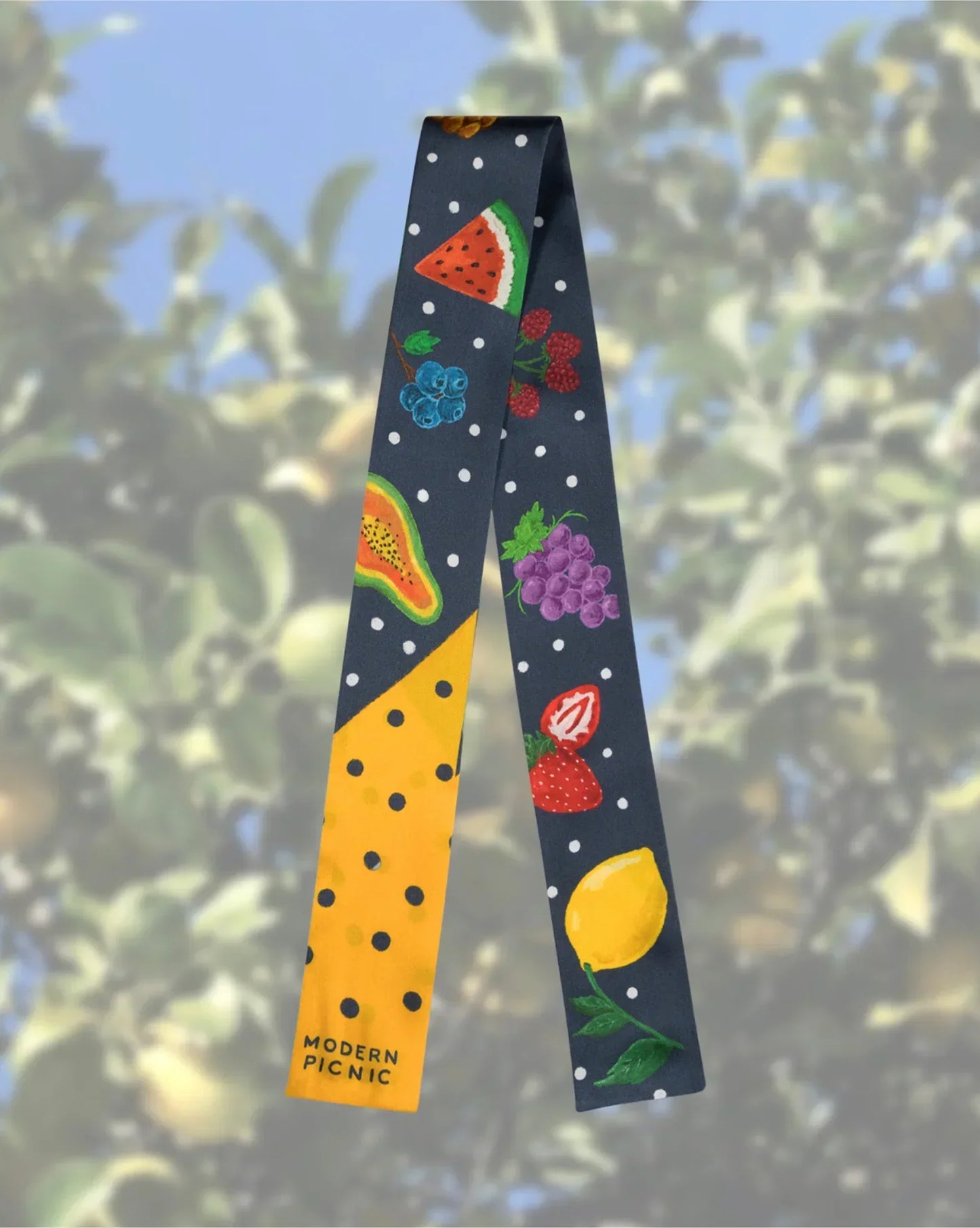 Colorful fruit-print scarf with watermelon, grapes, lemon on navy polka dot background, Modern Picnic brand