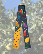 Colorful polka dot scarf with fruit pattern, featuring watermelon, grapes, lemon, and berries