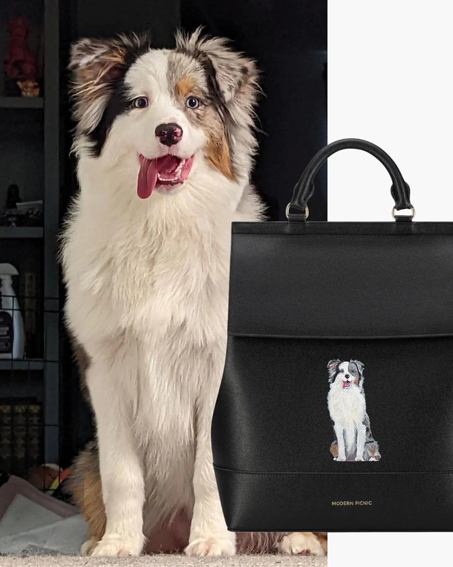 Fluffy dog sitting next to black vegan leather lunch tote with dog illustration and top handles
