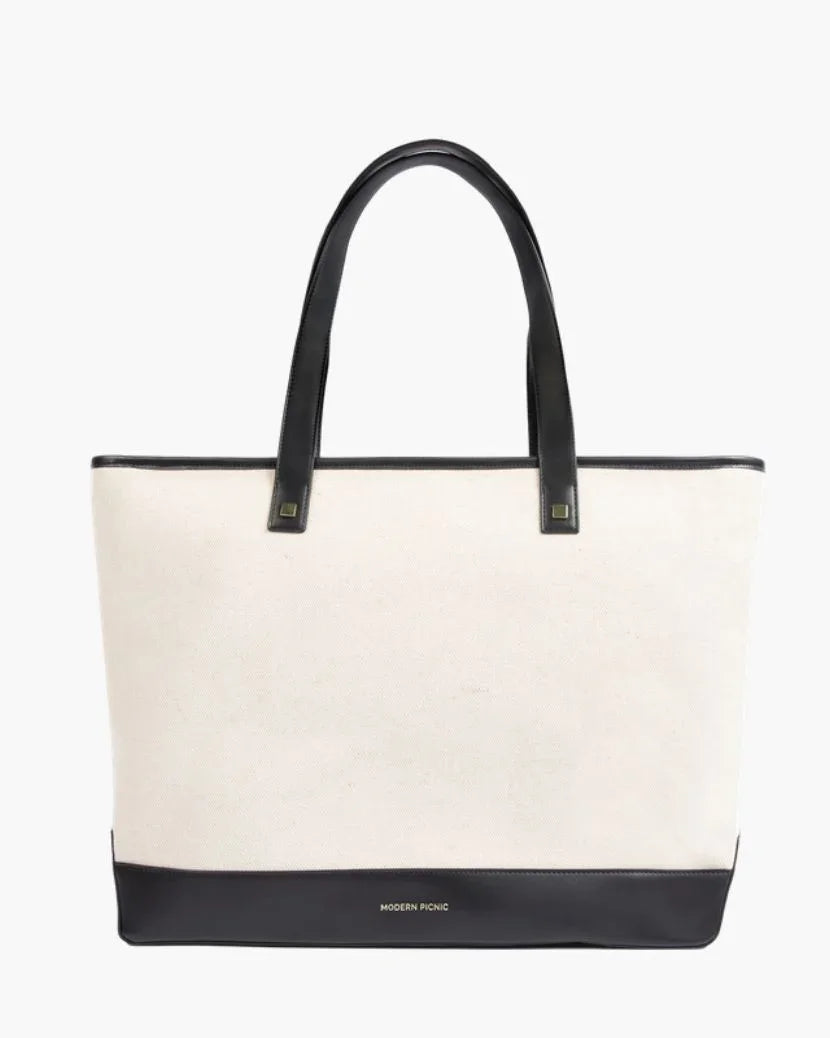 Cream canvas tote with black vegan leather handles and base, stylish insulated lunch bag for work or travel