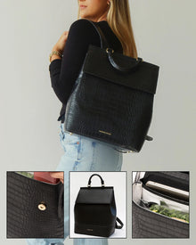 Woman wearing black vegan leather insulated backpack with croc texture and gold hardware, featuring lunch storage compartments.