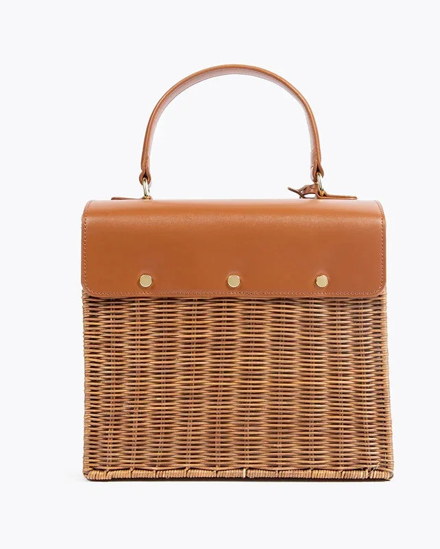 Tan wicker picnic tote with leather top handle and gold accents, chic insulated lunch bag for work or travel
