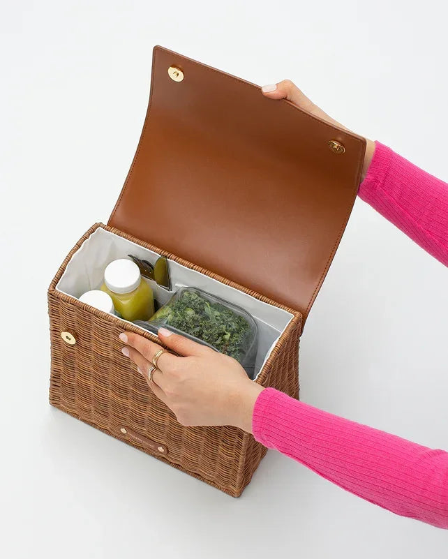 Woven picnic tote with insulated interior holding healthy lunch containers and drinks