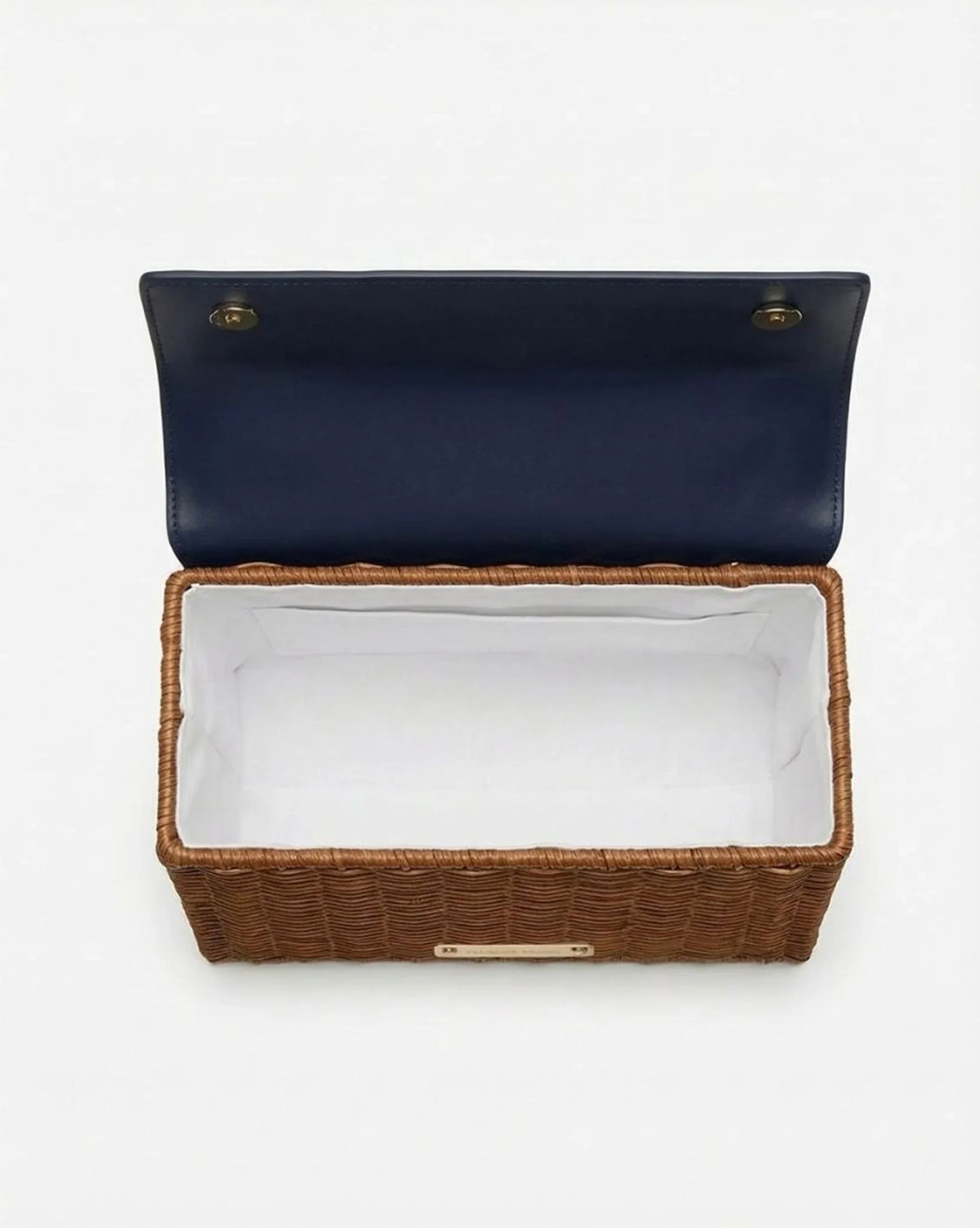 Woven basket-style lunch bag with navy lid and white interior lining, ideal for chic picnics or work meals.