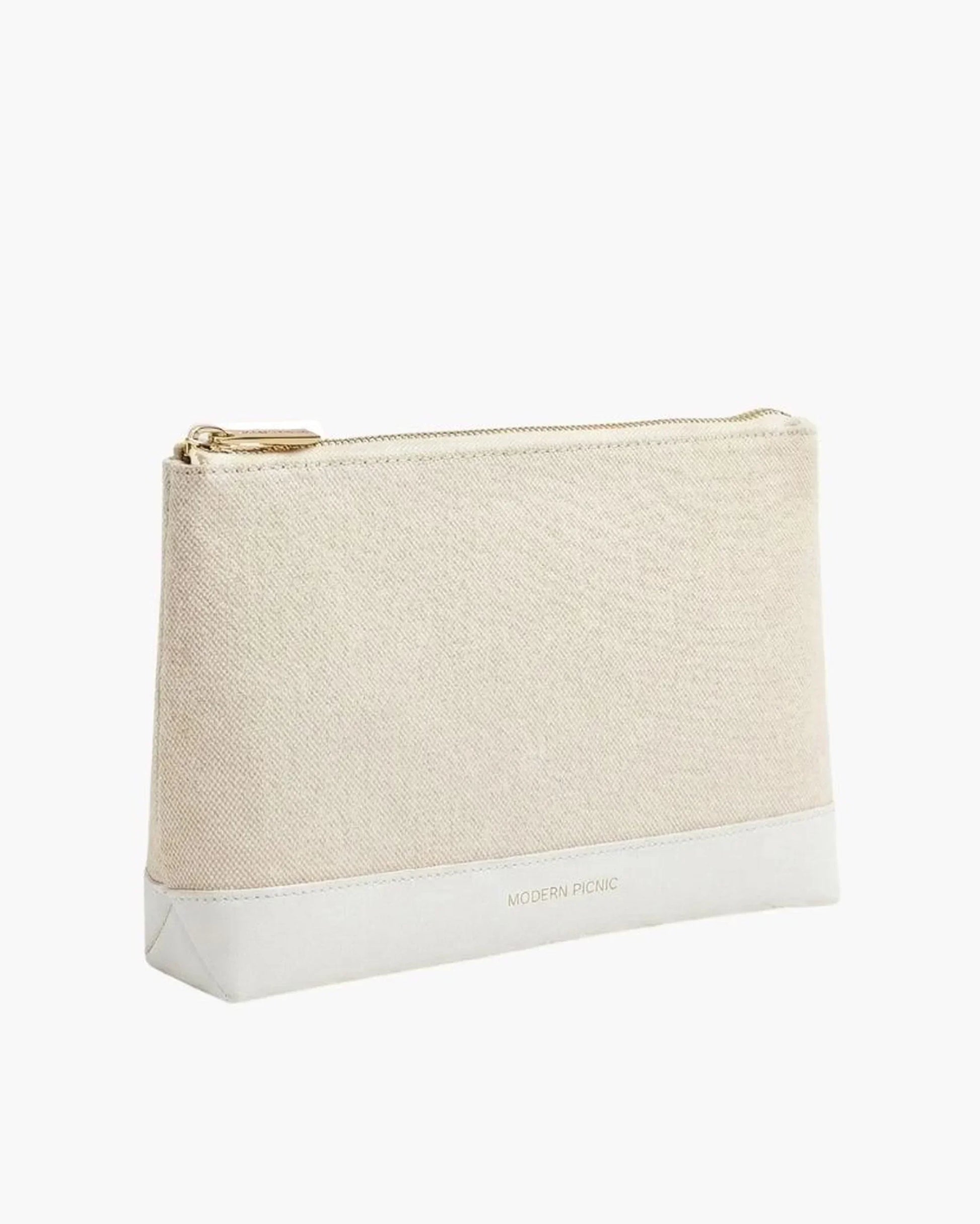 Beige canvas pouch with white vegan leather base and gold zipper, ideal for chic, insulated lunch storage.