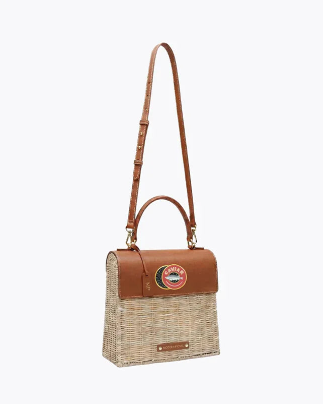 Woven picnic tote with vegan leather accents and adjustable strap, perfect for stylish outings.