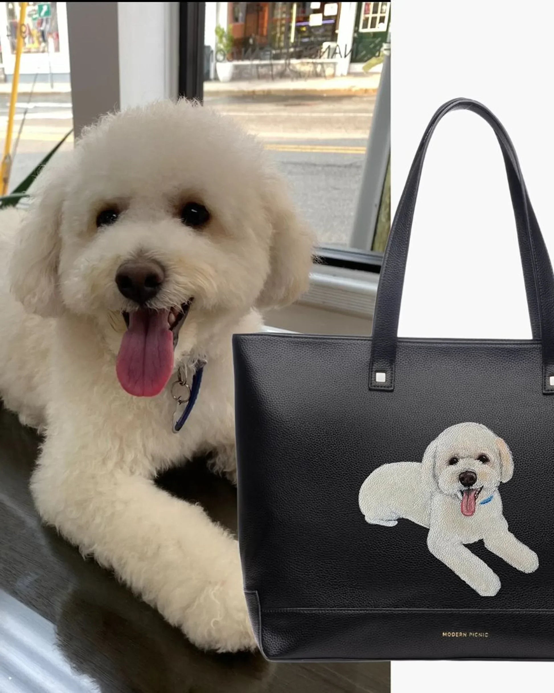 White fluffy dog next to black vegan leather tote with matching dog embroidery, insulated lunch bag