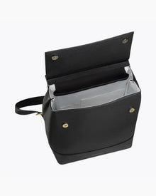 Top-down view of the open black Modern Picnic vegan leather backpack. The image highlights the contrast white insulated interior designed to keep food cool, along with the internal slip pockets and the gold-tone magnetic snap closures on the flap and body.