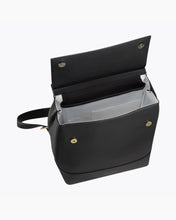 Top-down view of the open black Modern Picnic vegan leather backpack. The image highlights the contrast white insulated interior designed to keep food cool, along with the internal slip pockets and the gold-tone magnetic snap closures on the flap and body.