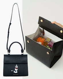 Black vegan leather insulated lunch bag purse with dog illustration and open view showing salad container inside.
