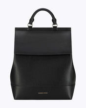 A sophisticated black backpack featuring a curved body, a structured top flap, a single top handle, and gold-tone hardware. The brand name "MODERN PICNIC" is subtly stamped in gold on the front base.