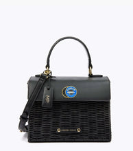 Front view of the Black Wicker Caviar Mini by Modern Picnic, featuring a hand-woven black wicker body, black vegan leather flap with a printed caviar graphic, top handle, and gold hardware.