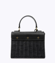 Back view of the Black Wicker Caviar Mini by Modern Picnic, showing the hand-woven black wicker exterior, black vegan leather flap, top handle, and gold hardware on a white background.