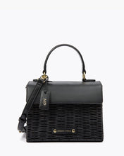 Modern Picnic black wicker and vegan leather mini top-handle bag with gold hardware and removable crossbody strap on a white background.