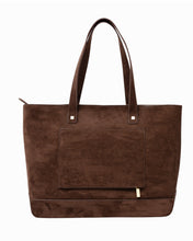 Full-front view of a brown suede tote bag with a square exterior slip pocket, suede handles, and gold hardware against a white background.