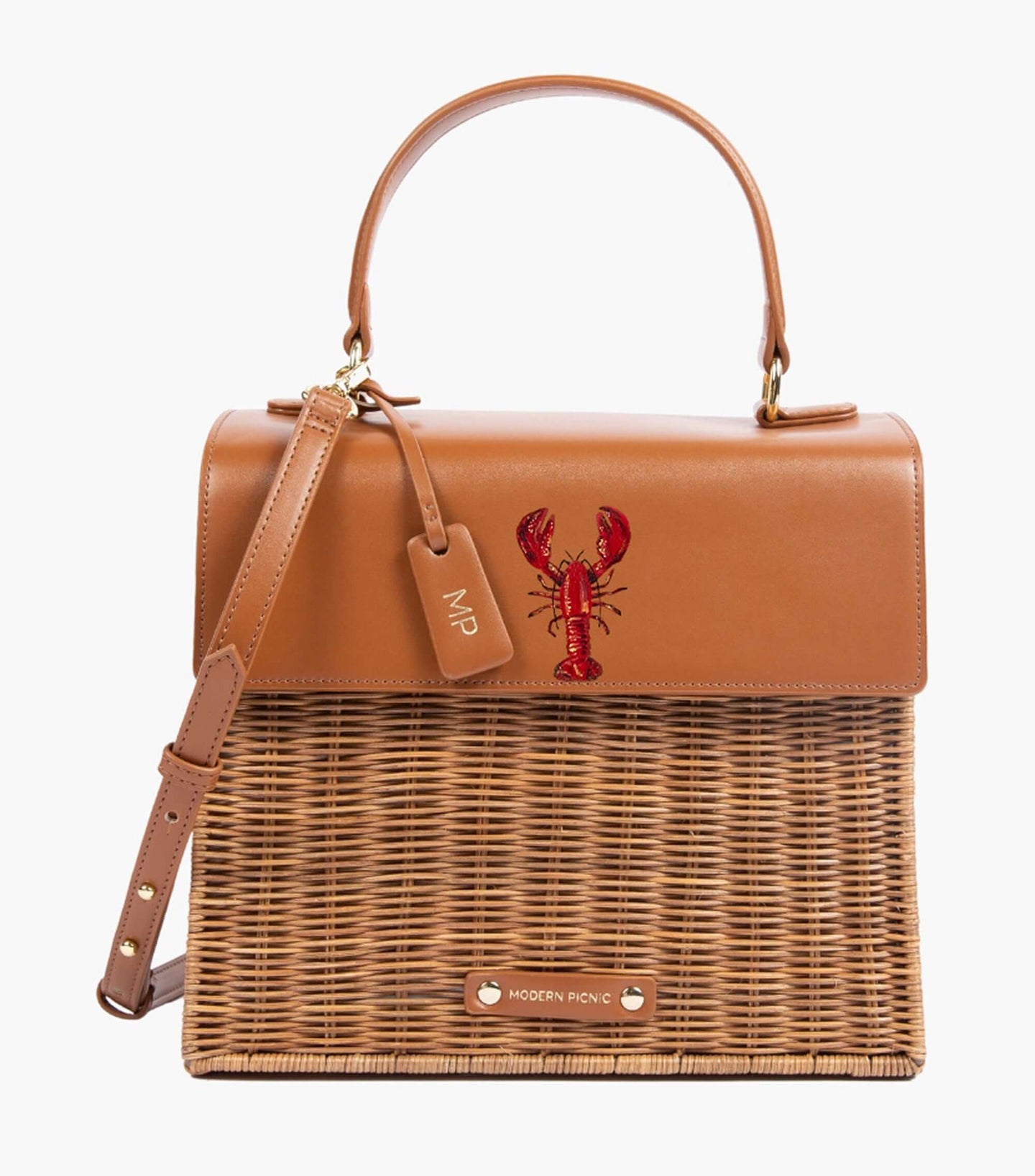 Front view of The Wicker Mini in Brown Wicker Lobster by Modern Picnic, featuring a hand-woven wicker exterior, brown vegan leather flap with a printed lobster, top handle, adjustable strap, and gold hardware.