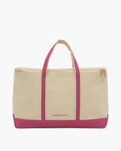 A front-facing studio shot of a wide beige canvas cooler tote bag. It has a bold pink base and two vertical pink stripes running up the center, which form the pink and beige top handles. The bag features a gold zipper closure and the logo "MODERN PICNIC" written in small pink text near the bottom.