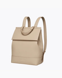 Angled view of the cream crocodile-embossed insulated backpack with adjustable shoulder straps and top carry handle.