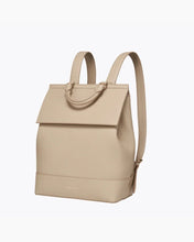 Angled view of the cream crocodile-embossed insulated backpack with adjustable shoulder straps and top carry handle.