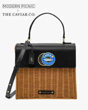 Black and brown lunchbox with 'The Caviar Co.' logo on a white background