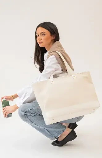 Stylish beige tote bag with vegan leather handles, perfect for work or travel