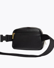 The back view of a black fanny pack with a gold zipper pull to a back pocket and a black strap. 