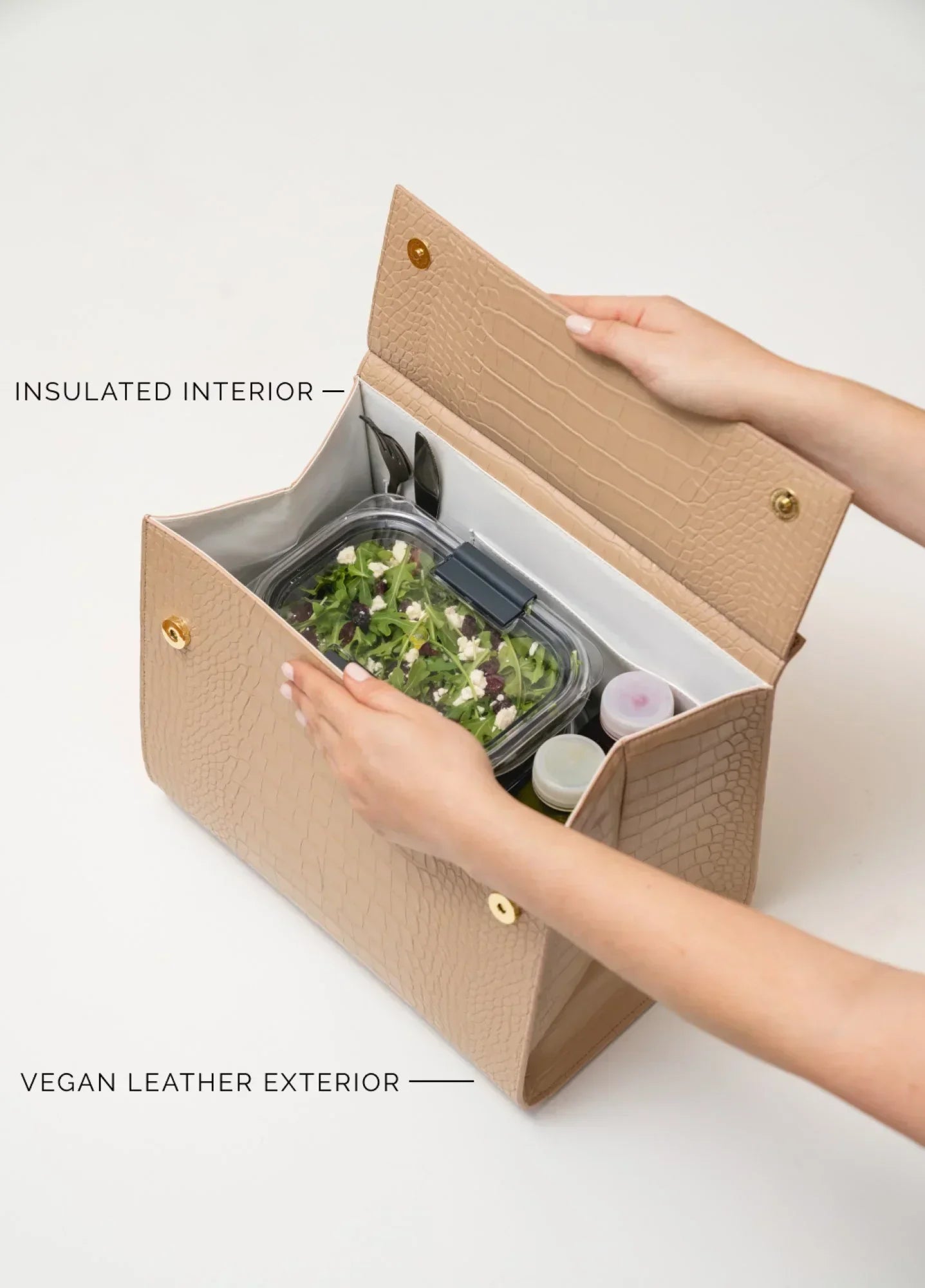Vegan leather lunch tote with insulated interior holding salad container and condiments, perfect for work or travel.