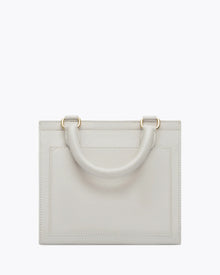 Back view of the Kids Mini Stone bag by Modern Picnic, showcasing the stone-colored vegan leather exterior with a structured rectangular shape, top handle, clean stitching, and gold hardware, displayed on a white background.