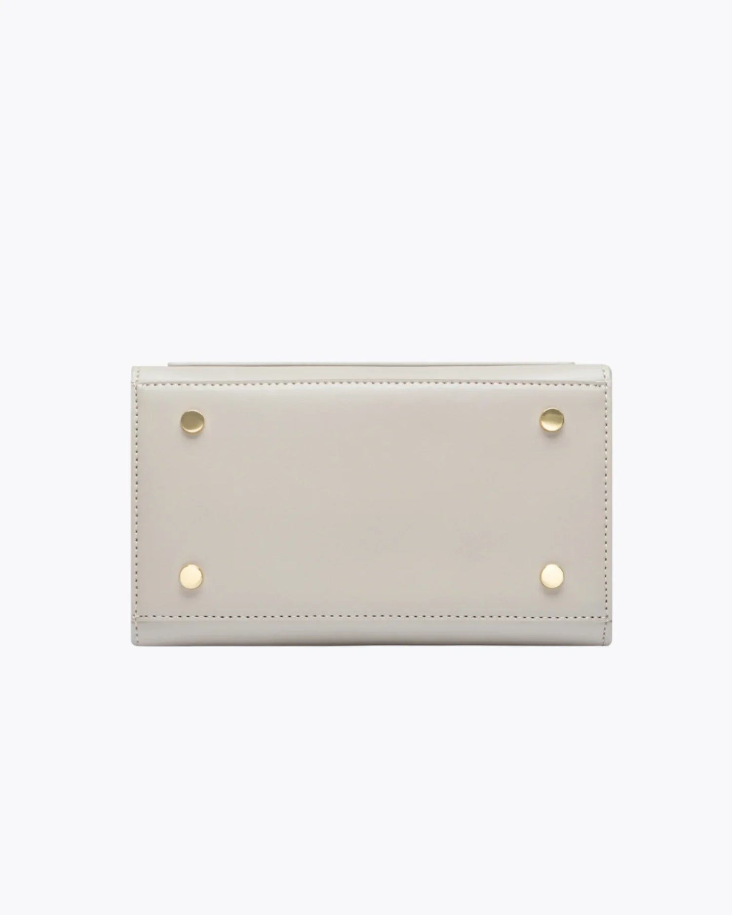 Bottom view of the Kids Mini Stone bag by Modern Picnic, showing the stone-colored vegan leather base with four gold metal feet, clean stitching, and a structured rectangular design displayed on a white background.