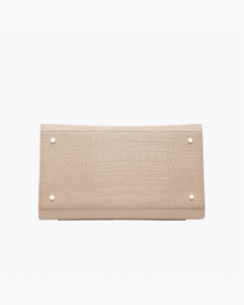 Beige vegan leather bag with crocodile texture and gold-tone stud accents, bottom view