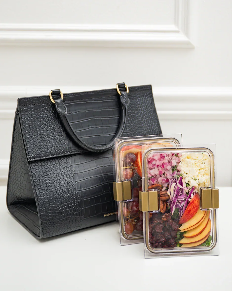 Black insulated faux leather croc lunch bag with two clear meal containers of salad