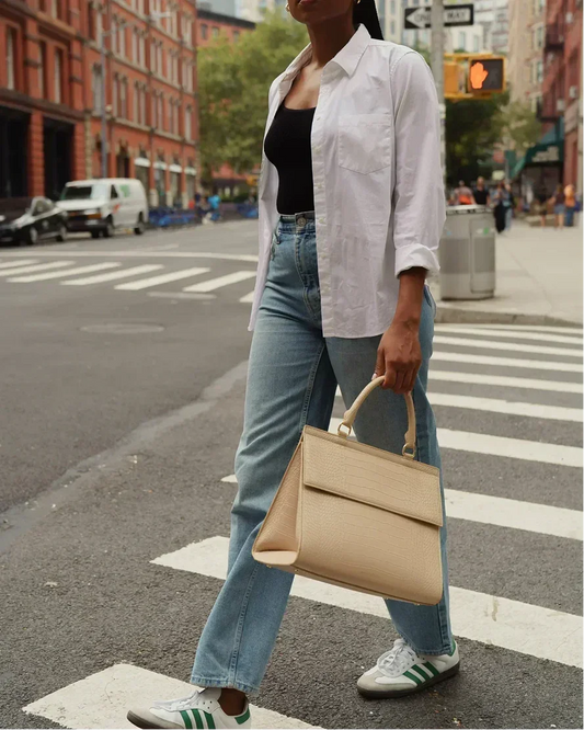 Woman crossing street with beige textured tote bag, styled for work or travel