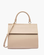 A front-facing studio shot of a structured top-handle handbag in a cream color with a flap closure. The bag features a detachable matching shoulder strap and small gold hardware. The logo, "MODERN PICNIC," is subtly embossed near the bottom.