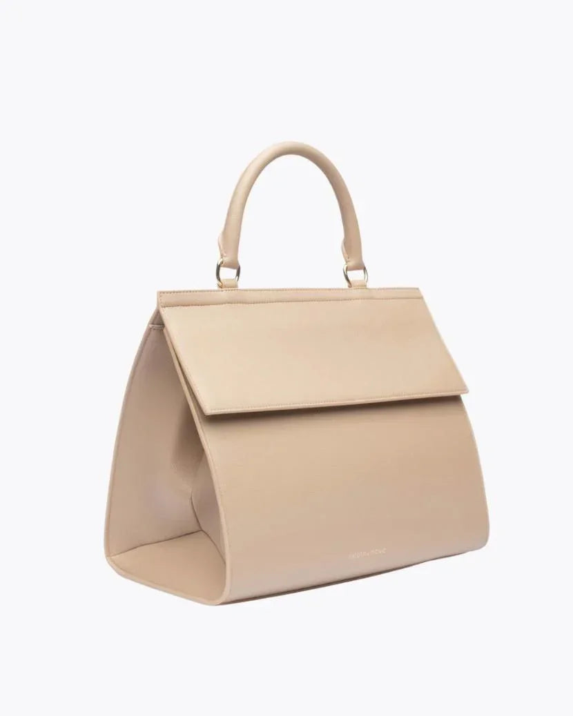 
A sophisticated, cream top-handle handbag made of pebbled faux leather, shown in a three-quarter view. The bag has a prominent flap closure and small gold hardware connecting the handle to the body. A faint logo is visible near the bottom of the front panel.