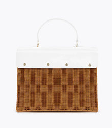 A back view of the structured picnic-style handbag. The bottom two-thirds of the bag are made of brown woven wicker, and the top flap is smooth white vegan leather. The back of the white flap is secured to the wicker body with four visible gold-tone fasteners.