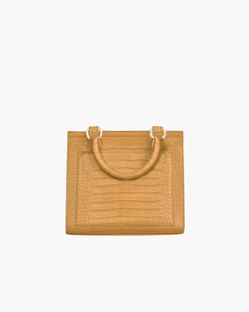 Back view of the Marigold Croc Kids Mini by Modern Picnic, featuring the marigold yellow croc-embossed vegan leather exterior, structured rectangular shape, stitched panel detailing, and dual top handles on a white background.